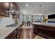 Open kitchen and living area featuring granite countertops and stainless steel appliances at 302 Kinney Glenn Ct, Durham, NC 27713