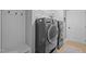Well-equipped laundry room featuring modern, front-load washer and dryer units at 302 Kinney Glenn Ct, Durham, NC 27713