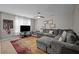 Living room with large sectional couch, ceiling fan, and natural light at 302 Kinney Glenn Ct, Durham, NC 27713