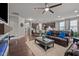 Open concept living space with hardwood floors, a brick fireplace, and view of the kitchen at 302 Kinney Glenn Ct, Durham, NC 27713