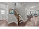 View of the staircase with dark wood floors, iron railings, and natural light at 302 Kinney Glenn Ct, Durham, NC 27713