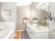 Bright bathroom with double sinks, white cabinets, and a soaking tub at 311 Pate St, Apex, NC 27502