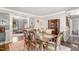 Formal dining room with a wooden table set for six, hardwood floors, and elegant furnishings at 311 Pate St, Apex, NC 27502