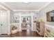 Inviting entryway with hardwood floors and decorative columns leading to the dining room at 311 Pate St, Apex, NC 27502