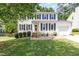 Traditional two-story home with white siding, black shutters, and a well-manicured lawn at 311 Pate St, Apex, NC 27502