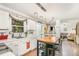Bright kitchen featuring white cabinetry, stainless steel sink, and a center island with seating at 311 Pate St, Apex, NC 27502