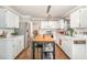 Updated kitchen with white cabinetry, stainless appliances, and a center island for food prep at 311 Pate St, Apex, NC 27502