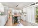 Modern kitchen with white cabinets, stainless steel appliances, and an island with bar seating at 311 Pate St, Apex, NC 27502
