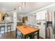 Open kitchen with an island, hardwood floors, and a view into the living room at 311 Pate St, Apex, NC 27502