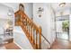 Elegant staircase with wooden banister, carpeted steps and neutral wall paint at 311 Pate St, Apex, NC 27502