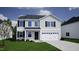 Charming two-story home featuring a gray exterior, black shutters, and a two-car garage at 315 Alice Trace Place, Angier, NC 27501