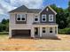 Two-story home with gray siding, a covered entryway, and an attached two-car garage at 316 Alice Trace Place, Angier, NC 27501