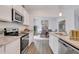 Kitchen with stainless steel appliances, granite counters, and view into the dining room at 316 Alice Trace Place, Angier, NC 27501