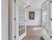 Bright room with French doors, ceiling fan, and wood-look flooring at 316 Alice Trace Place, Angier, NC 27501