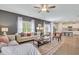 Cozy living room with large windows, comfortable seating, and view into the kitchen at 316 Alice Trace Place, Angier, NC 27501