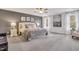 Main bedroom featuring a ceiling fan, ensuite bathroom, and multiple windows for natural light at 316 Alice Trace Place, Angier, NC 27501