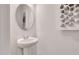 Stylish powder room featuring a pedestal sink and modern decor at 316 Alice Trace Place, Angier, NC 27501