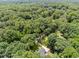 Aerial view of a house surrounded by lush, mature trees and foliage, showing the long driveway at 3204 Manor Ridge Dr, Raleigh, NC 27603