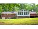Back exterior of the home featuring a sunroom and backyard at 3204 Manor Ridge Dr, Raleigh, NC 27603