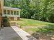 Landscaped backyard featuring a patio, lush greenery, and mature trees at 3204 Manor Ridge Dr, Raleigh, NC 27603