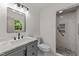 Bathroom featuring vanity, toilet, and walk-in shower with decorative tile at 3204 Manor Ridge Dr, Raleigh, NC 27603