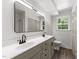 Bright bathroom featuring a double vanity, modern fixtures, and a large mirror at 3204 Manor Ridge Dr, Raleigh, NC 27603