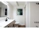 Bright bathroom features a sleek vanity with modern fixtures and a shower with updated hardware at 3204 Manor Ridge Dr, Raleigh, NC 27603