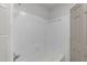 Clean bathroom featuring white tile, white tub, and updated fixtures at 3204 Manor Ridge Dr, Raleigh, NC 27603