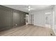 A freshly painted bedroom featuring light-colored wood-look floors and gray accent wall at 3204 Manor Ridge Dr, Raleigh, NC 27603