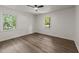 Bright, airy bedroom featuring hardwood floors, ceiling fan, and ample natural light at 3204 Manor Ridge Dr, Raleigh, NC 27603