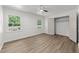 Bedroom with hardwood floors, closet, and natural light from large windows at 3204 Manor Ridge Dr, Raleigh, NC 27603
