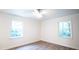 Bedroom with natural light streaming through the windows, enhanced by sleek floors and a modern ceiling fan at 3204 Manor Ridge Dr, Raleigh, NC 27603