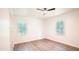 Bright bedroom with wood-look floors, a ceiling fan, two windows, and neutral walls at 3204 Manor Ridge Dr, Raleigh, NC 27603