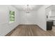 Open dining room with hardwood floors, white walls, and a modern chandelier at 3204 Manor Ridge Dr, Raleigh, NC 27603