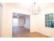 Bright dining room features modern chandelier, wainscoting, and wood-look floors at 3204 Manor Ridge Dr, Raleigh, NC 27603