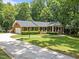 Charming brick home with manicured lawn, black shutters and a welcoming front porch at 3204 Manor Ridge Dr, Raleigh, NC 27603
