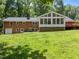 A spacious brick home featuring an enclosed sunroom addition and deck at 3204 Manor Ridge Dr, Raleigh, NC 27603