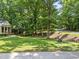 Well-manicured front yard with mature trees and landscaping for privacy at 3204 Manor Ridge Dr, Raleigh, NC 27603
