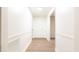 Inviting hallway featuring clean lines and a neutral palette, leading to the front door at 3204 Manor Ridge Dr, Raleigh, NC 27603
