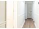Bright hallway with wood-look floors and fresh white walls with a decorative trim at 3204 Manor Ridge Dr, Raleigh, NC 27603