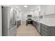 Modern kitchen with stainless steel appliances, white cabinets, and wood flooring at 3204 Manor Ridge Dr, Raleigh, NC 27603