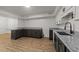 Basement kitchenette featuring stone countertops, modern cabinets, and sleek hardware at 3204 Manor Ridge Dr, Raleigh, NC 27603