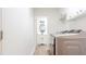 Well-lit laundry room featuring modern appliances and ample storage, leading into a half bathroom at 3204 Manor Ridge Dr, Raleigh, NC 27603