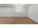 Open-concept living room featuring wood-look flooring and neutral decor at 3204 Manor Ridge Dr, Raleigh, NC 27603