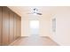 Bright living room with wood paneling and a ceiling fan at 3204 Manor Ridge Dr, Raleigh, NC 27603