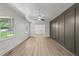 A spacious living room with hardwood floors, white walls, and modern paneling at 3204 Manor Ridge Dr, Raleigh, NC 27603