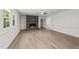 Open living room featuring hardwood floors, a brick fireplace, and large windows at 3204 Manor Ridge Dr, Raleigh, NC 27603