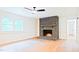 Open living room featuring a brick fireplace and wood floors at 3204 Manor Ridge Dr, Raleigh, NC 27603