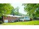 Brick home with enclosed sunroom, patio and spacious backyard at 3204 Manor Ridge Dr, Raleigh, NC 27603