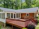 An exterior view of a sunroom and deck, perfect for outdoor enjoyment at 3204 Manor Ridge Dr, Raleigh, NC 27603